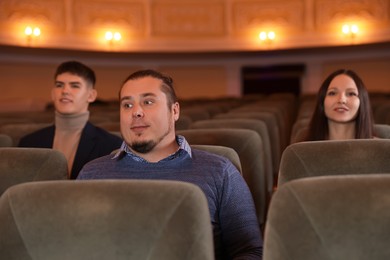 Photo of Group of people watching theatrical performance in theatre