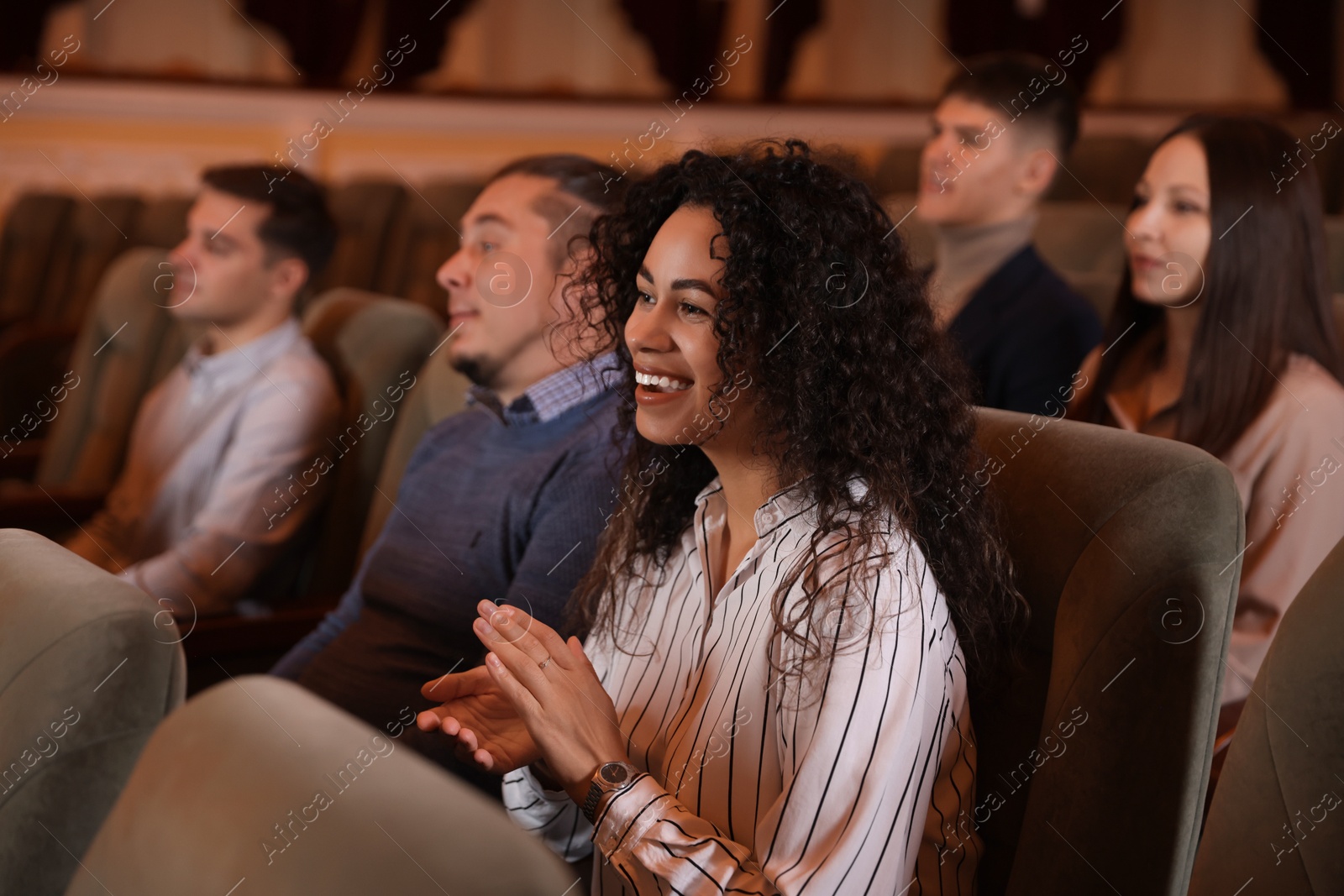 Photo of Group of people watching theatrical performance in theatre