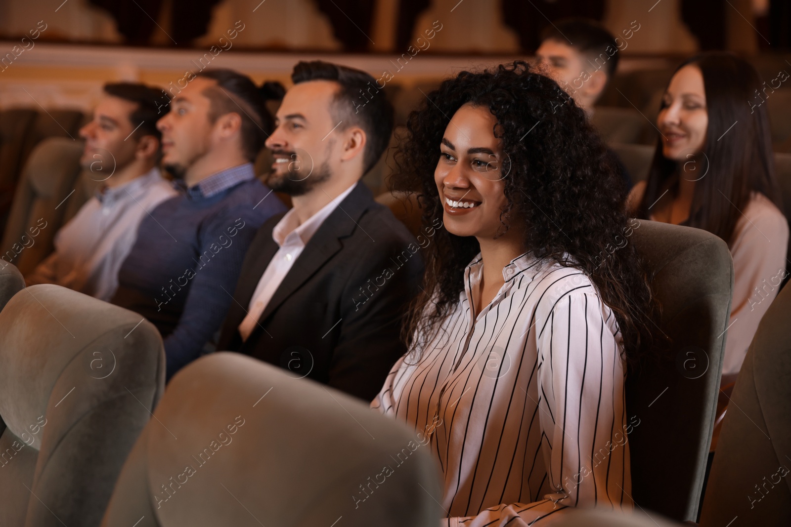 Photo of Group of people watching theatrical performance in theatre