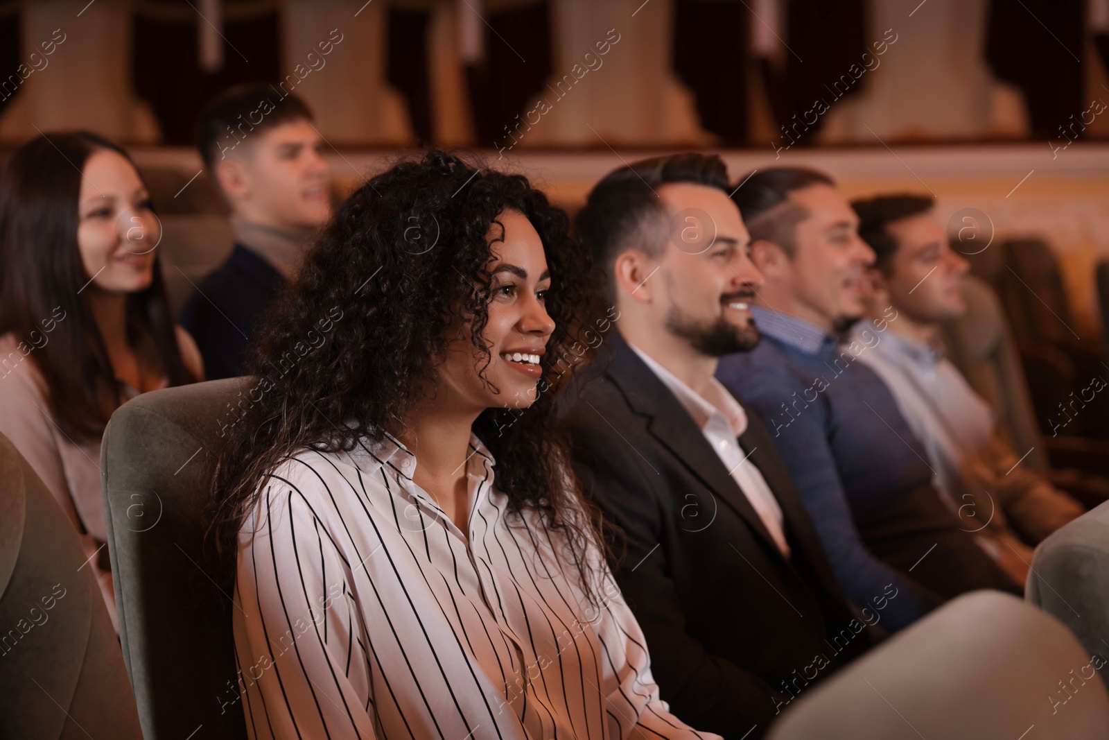 Photo of Group of people watching theatrical performance in theatre