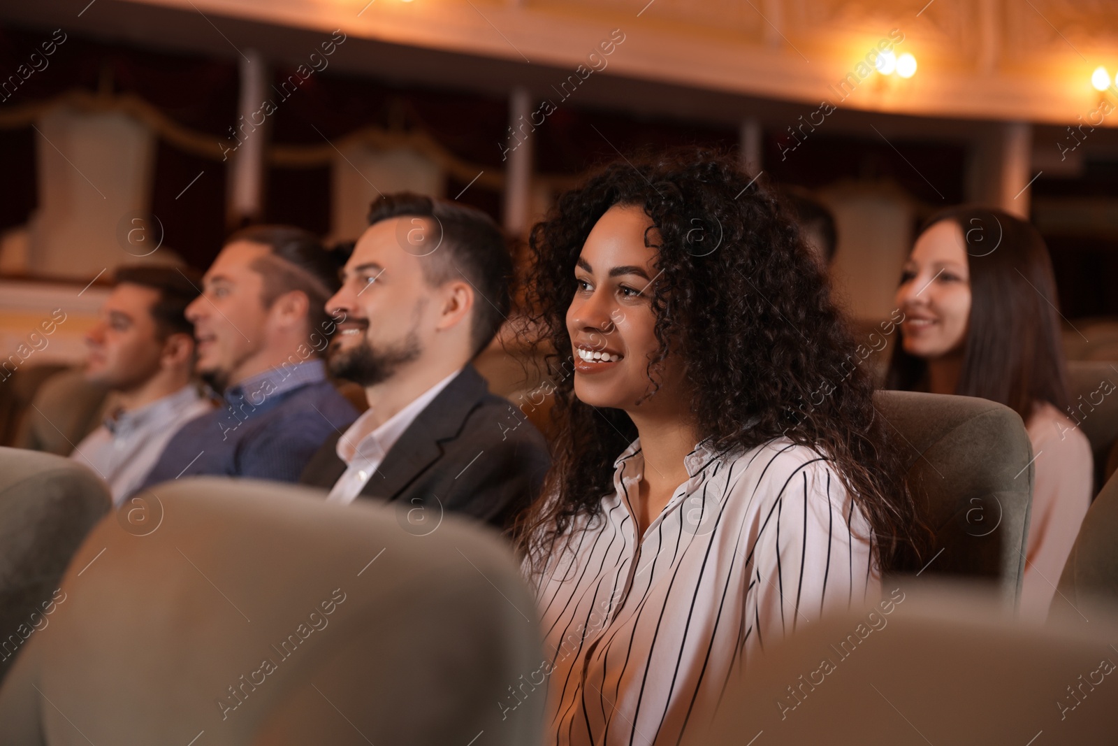 Photo of Group of people watching theatrical performance in theatre