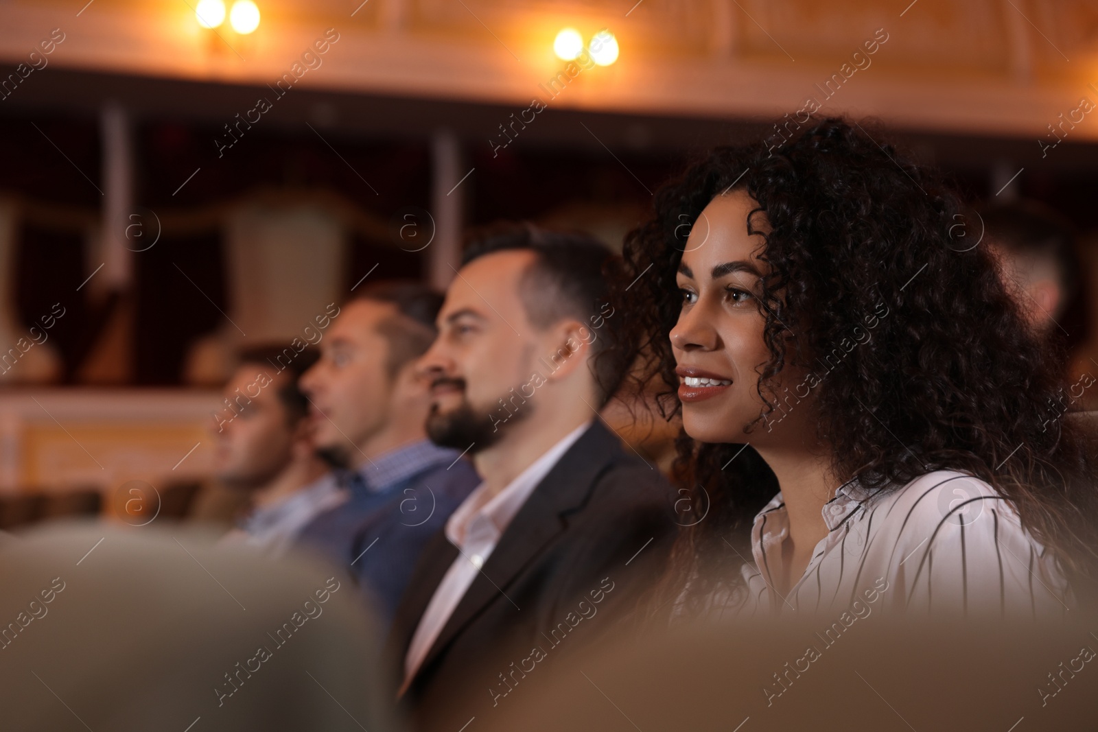 Photo of Group of people watching theatrical performance in theatre