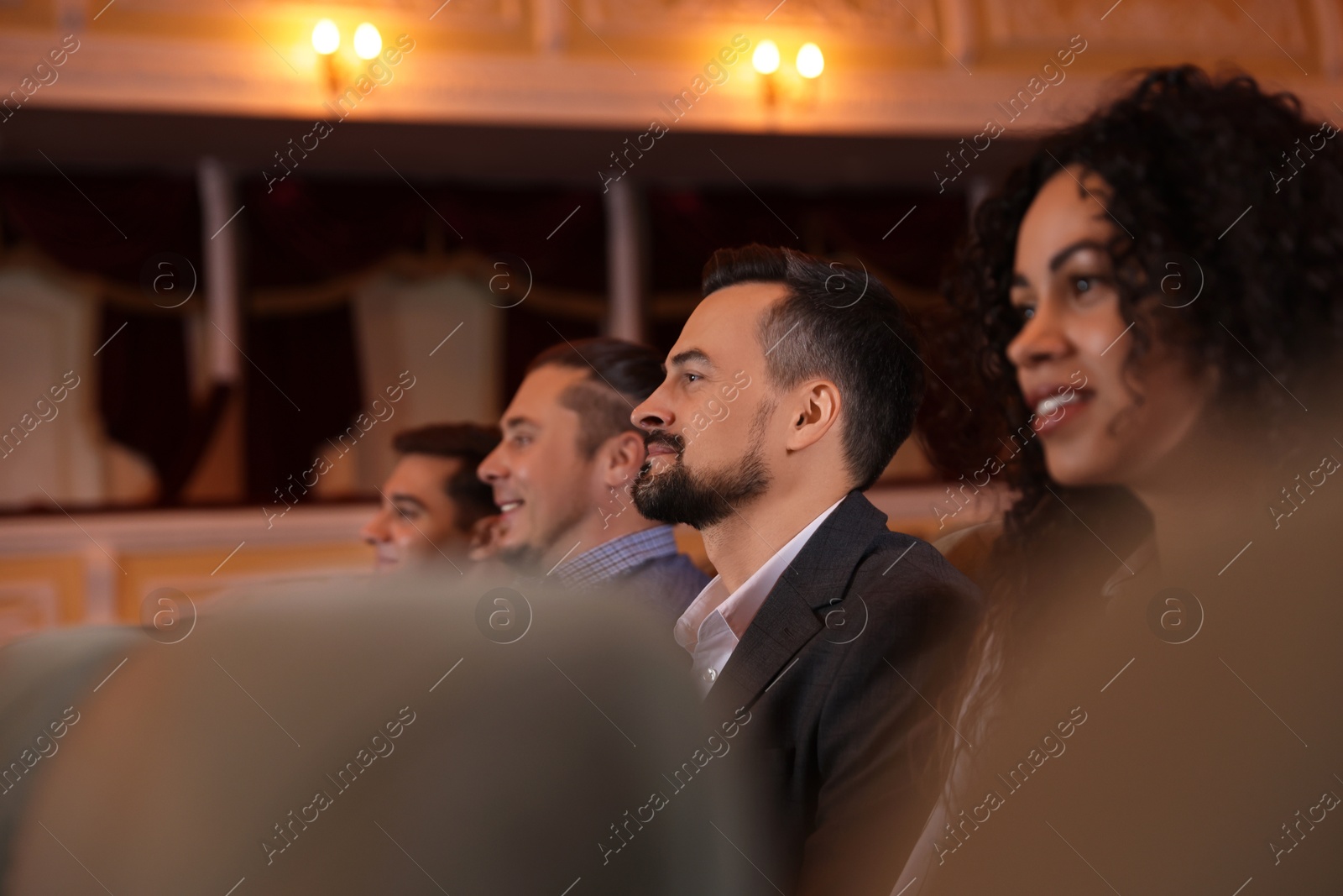 Photo of Group of people watching theatrical performance in theatre