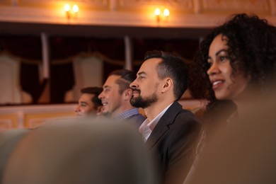 Photo of Group of people watching theatrical performance in theatre