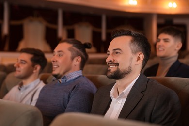 Photo of Group of people watching theatrical performance in theatre