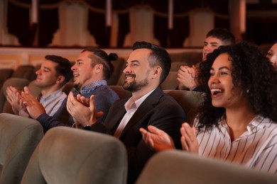 Photo of Group of exited people applauding in theatre