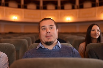 Photo of Man and woman watching theatrical performance in theatre