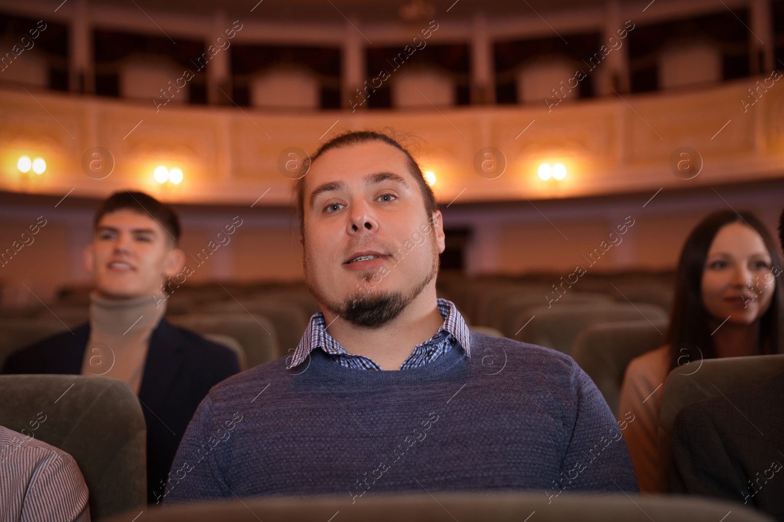 Photo of Group of people watching theatrical performance in theatre