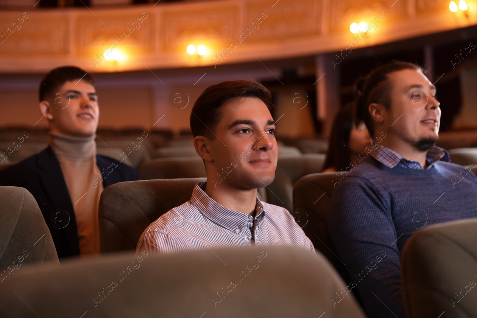 Photo of Group of people watching theatrical performance in theatre