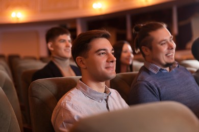 Photo of Group of people watching theatrical performance in theatre