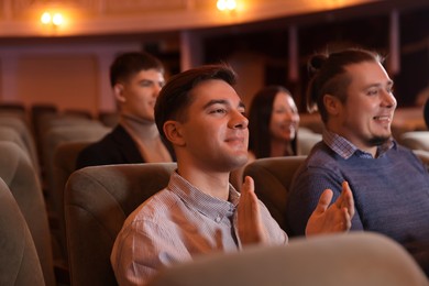 Photo of Group of people watching theatrical performance in theatre