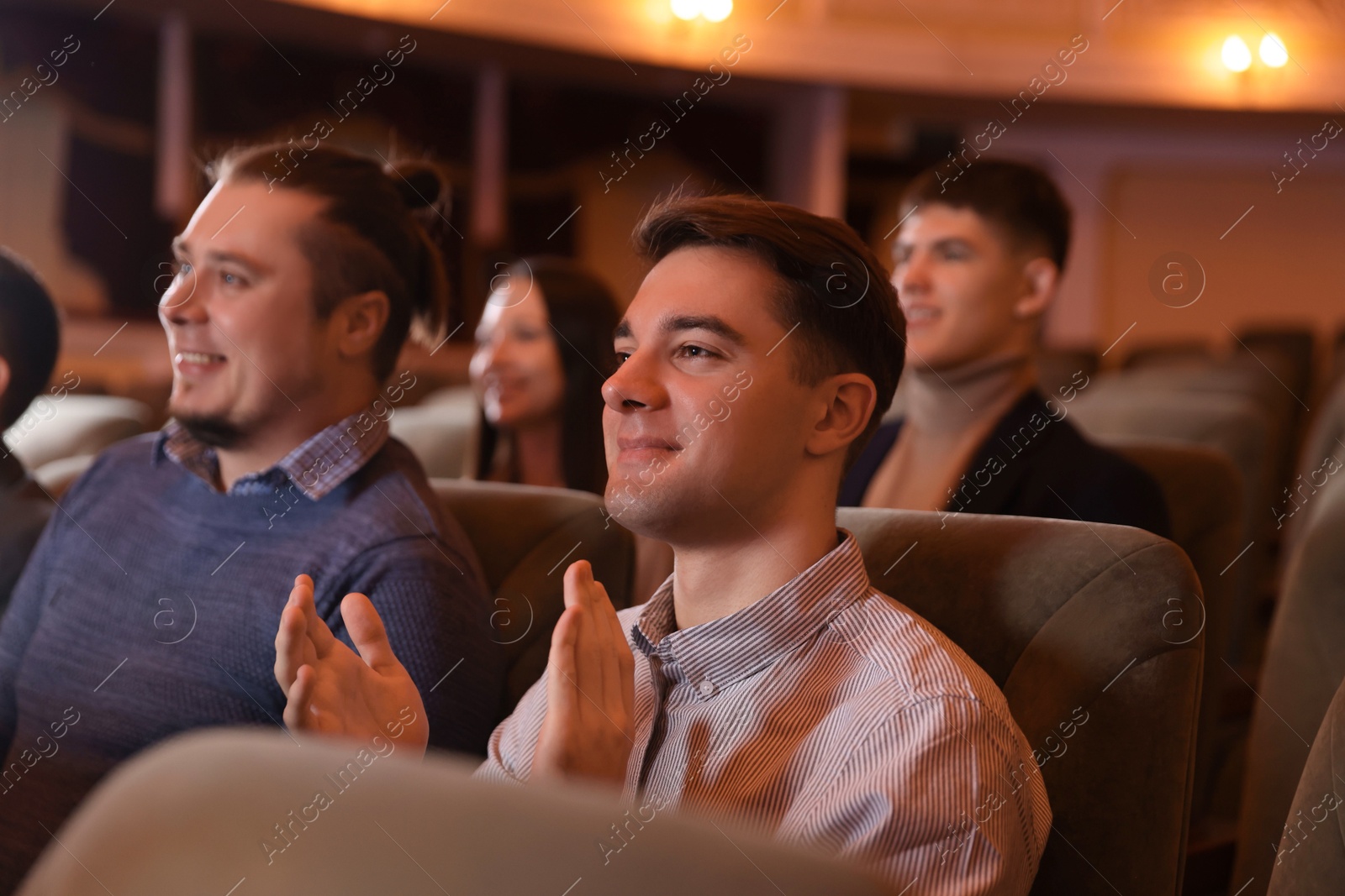 Photo of Group of people watching theatrical performance in theatre