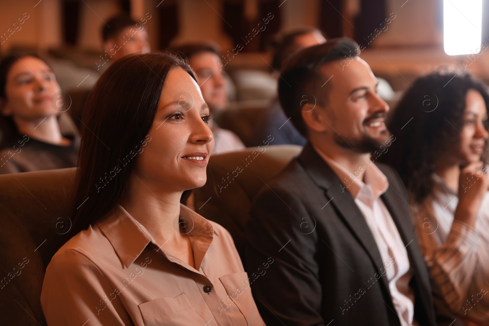 Photo of Group of people watching theatrical performance in theatre