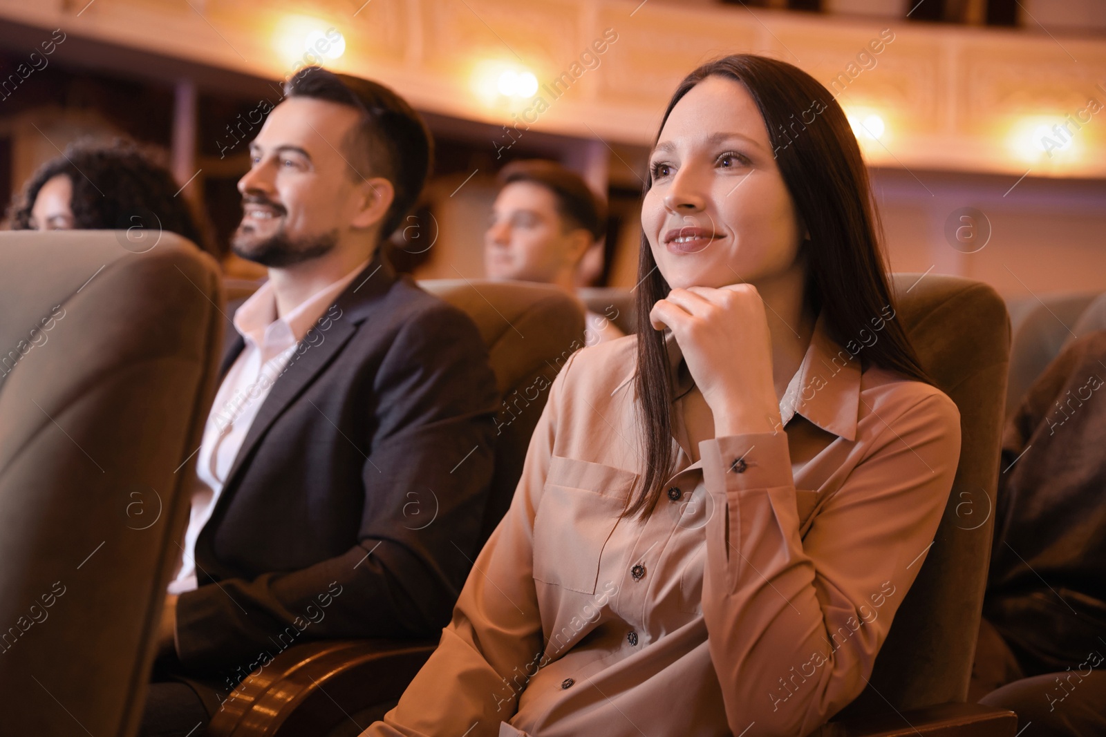 Photo of Group of people watching theatrical performance in theatre