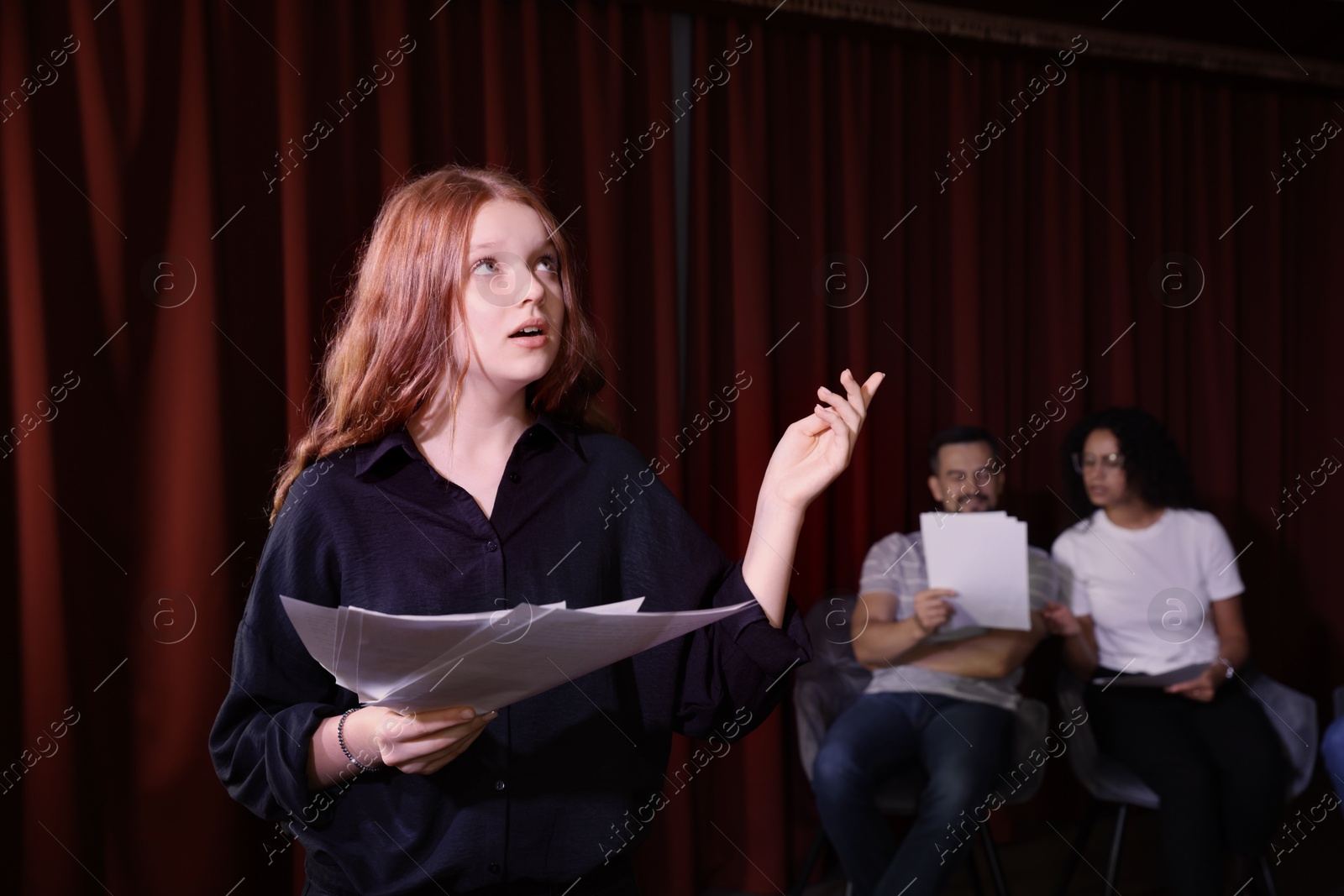 Photo of Professional actress rehearsing on stage in theatre