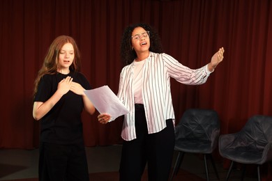 Photo of Professional actors rehearsing on stage in theatre