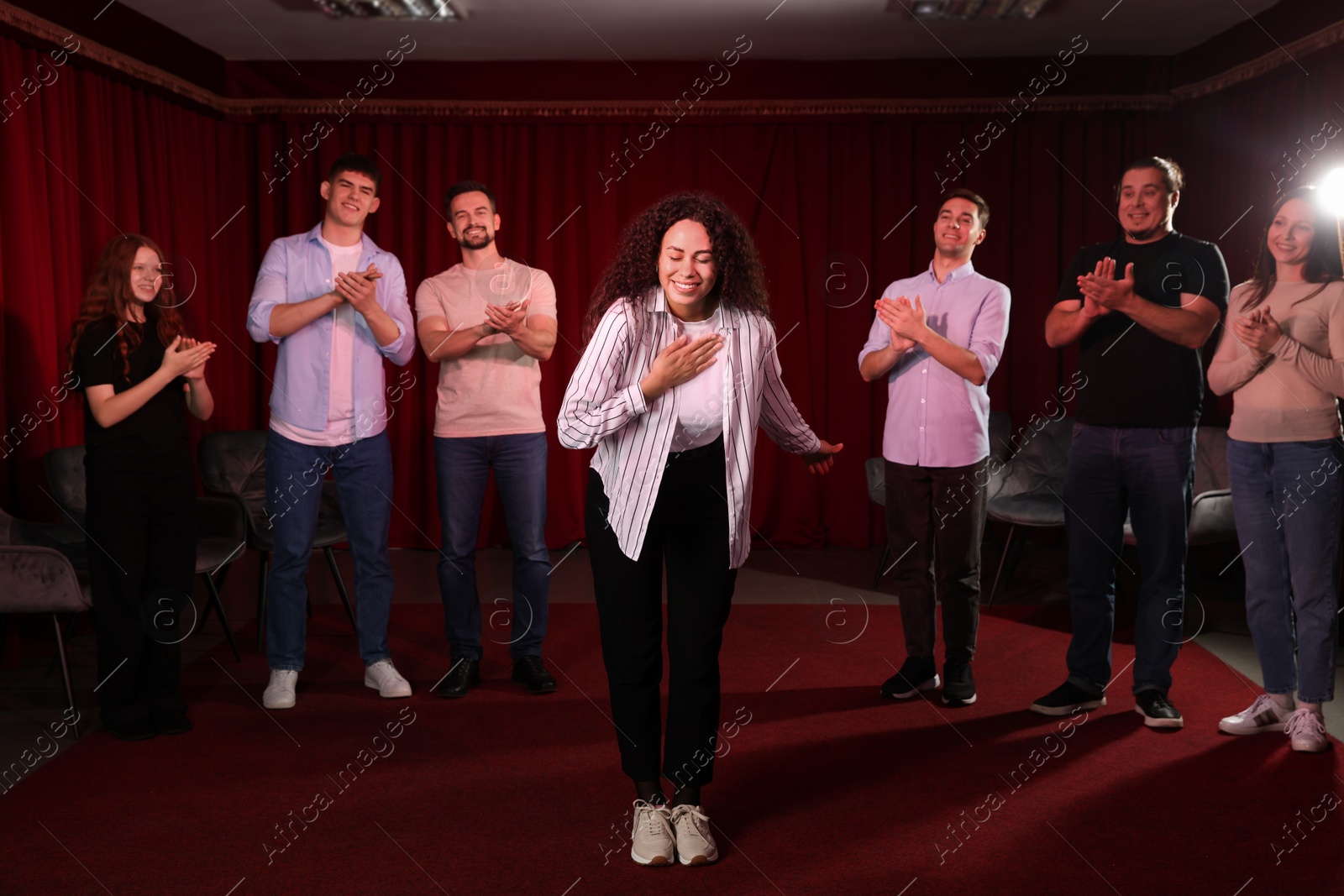 Photo of Professional actors bowing on stage in theatre