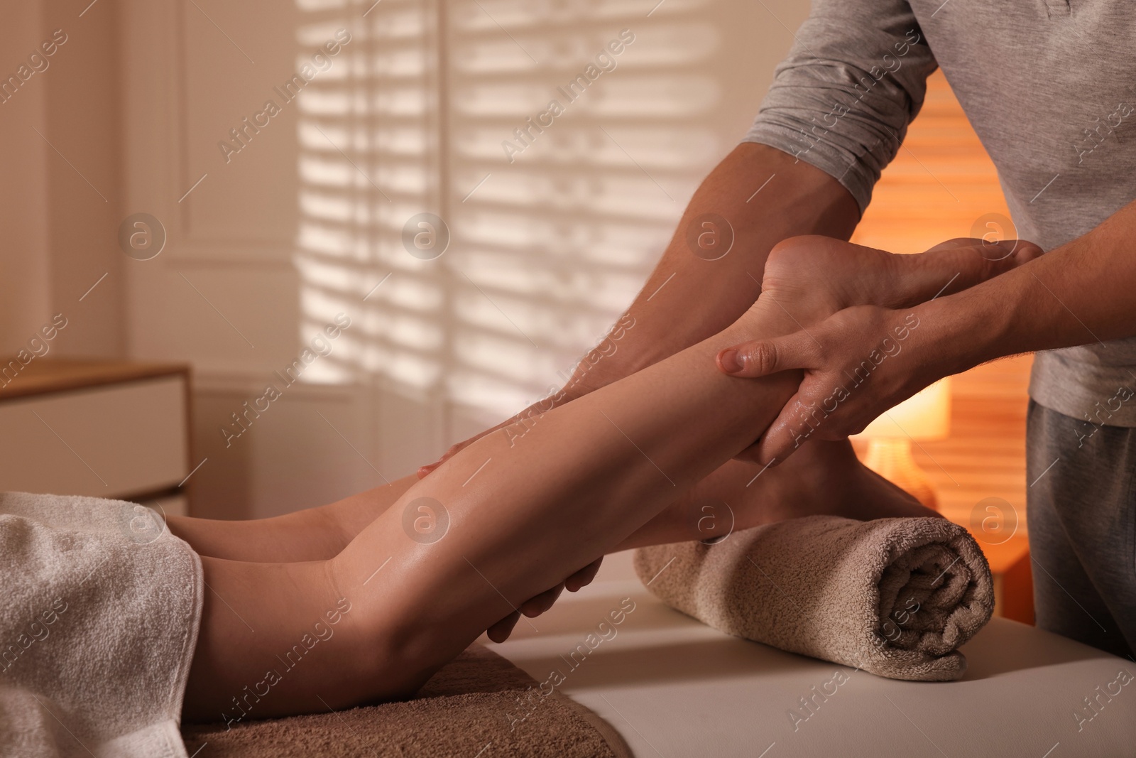 Photo of Osteopath working with patient indoors, closeup. Manual therapy