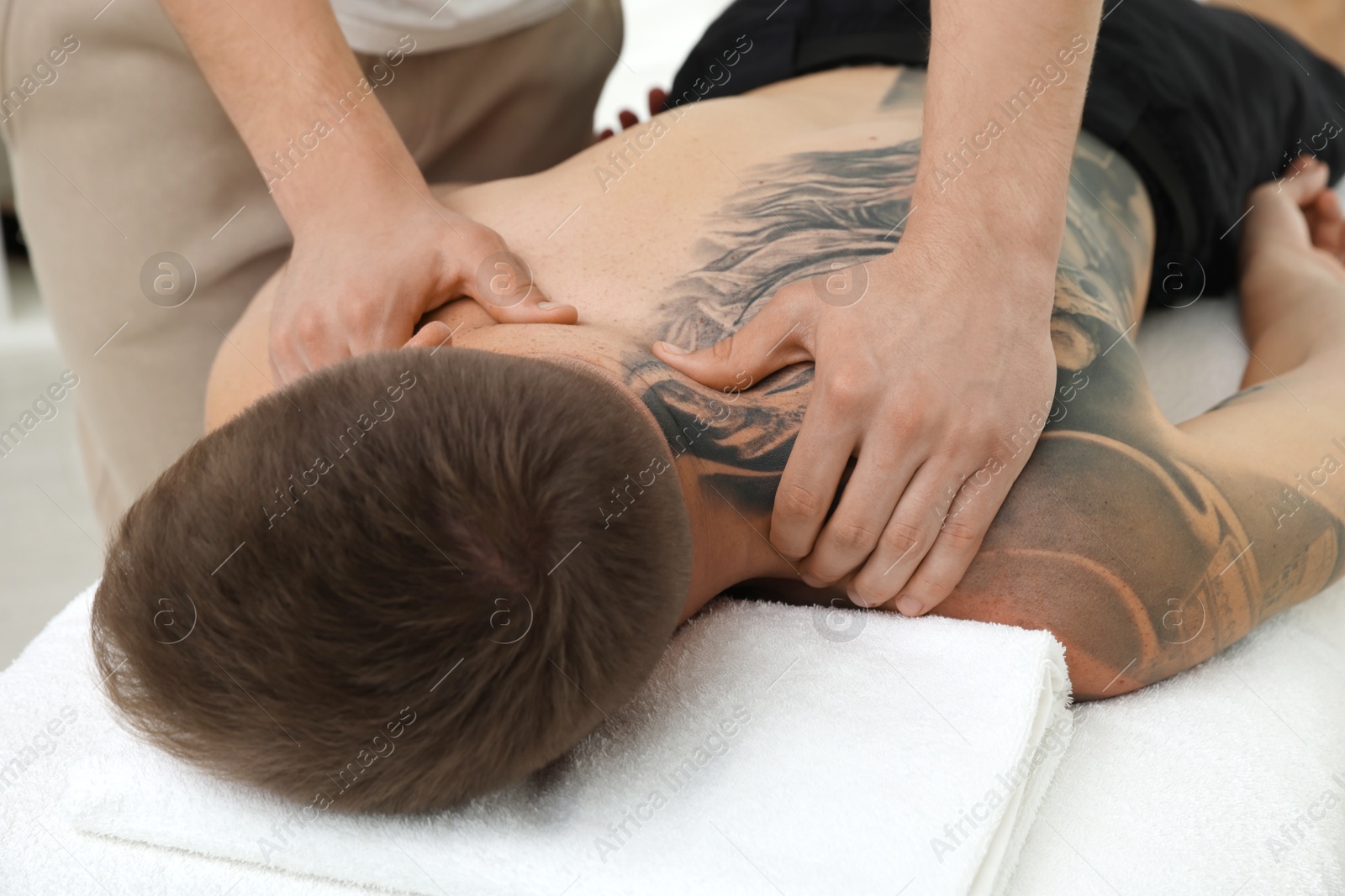 Photo of Massage therapist working with patient in clinic, closeup