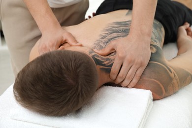 Photo of Massage therapist working with patient in clinic, closeup