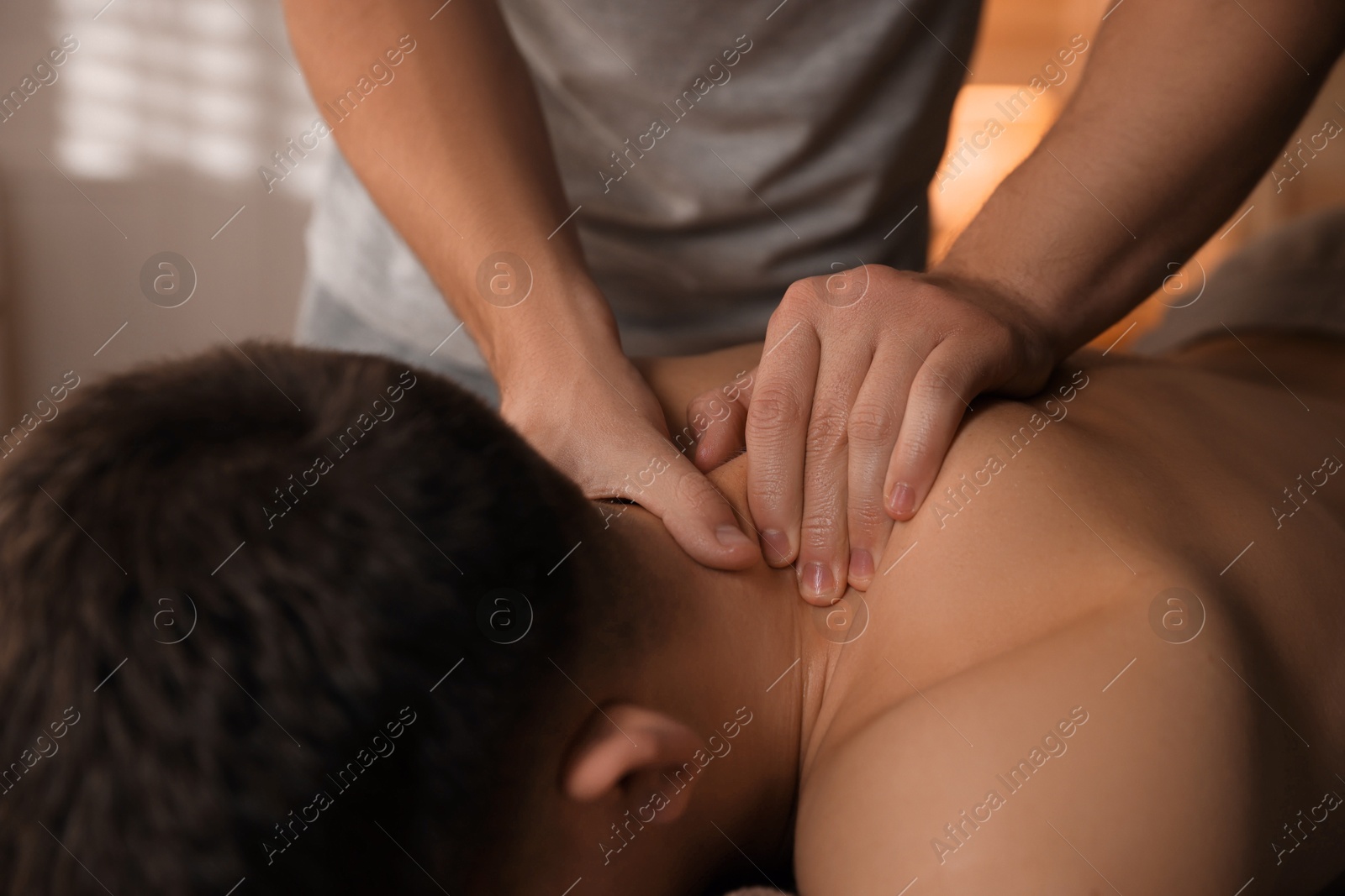 Photo of Massage therapist working with patient in clinic, closeup