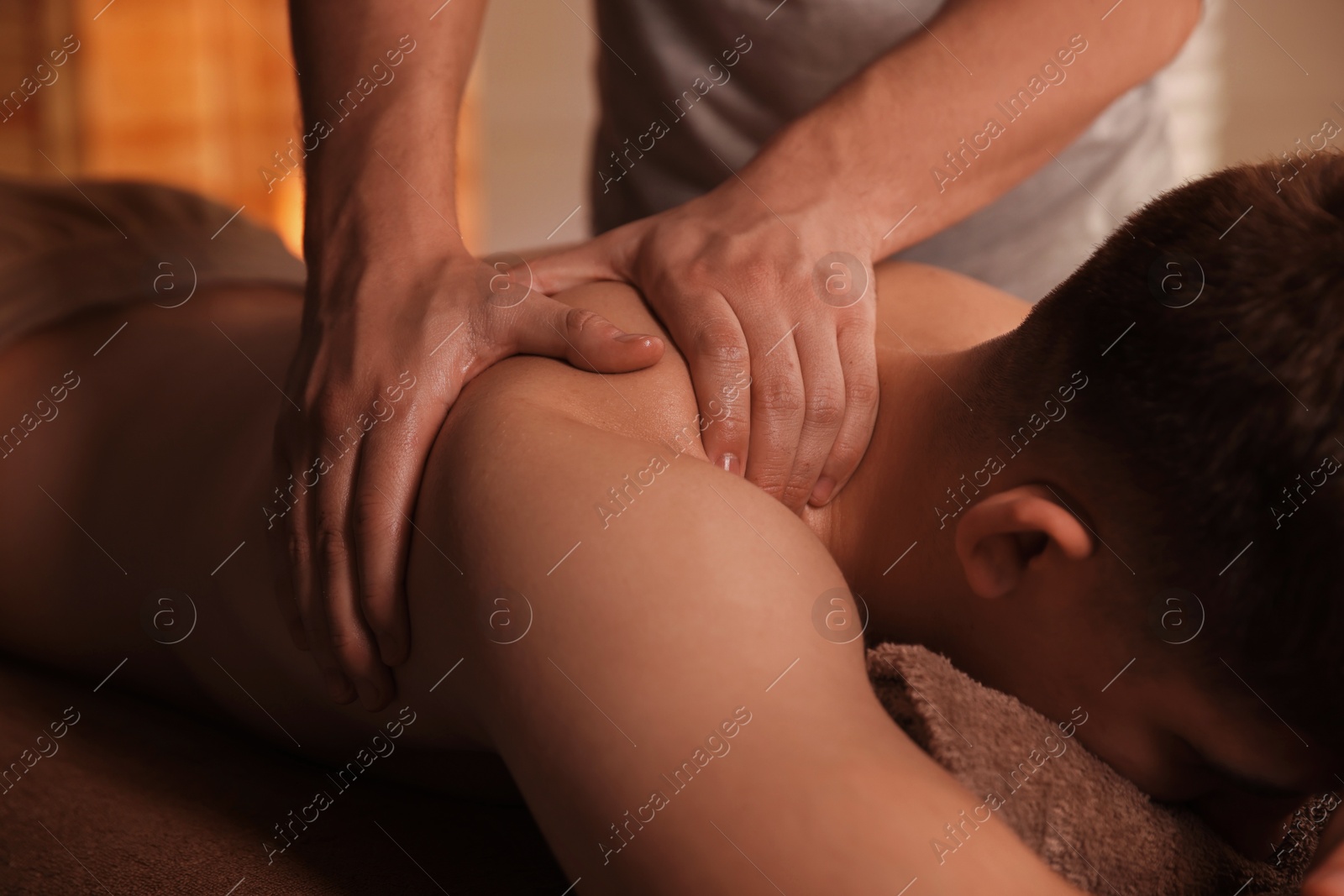 Photo of Massage therapist working with patient in clinic, closeup