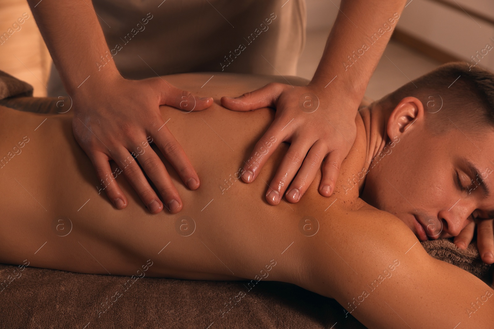 Photo of Massage therapist working with patient in clinic, closeup