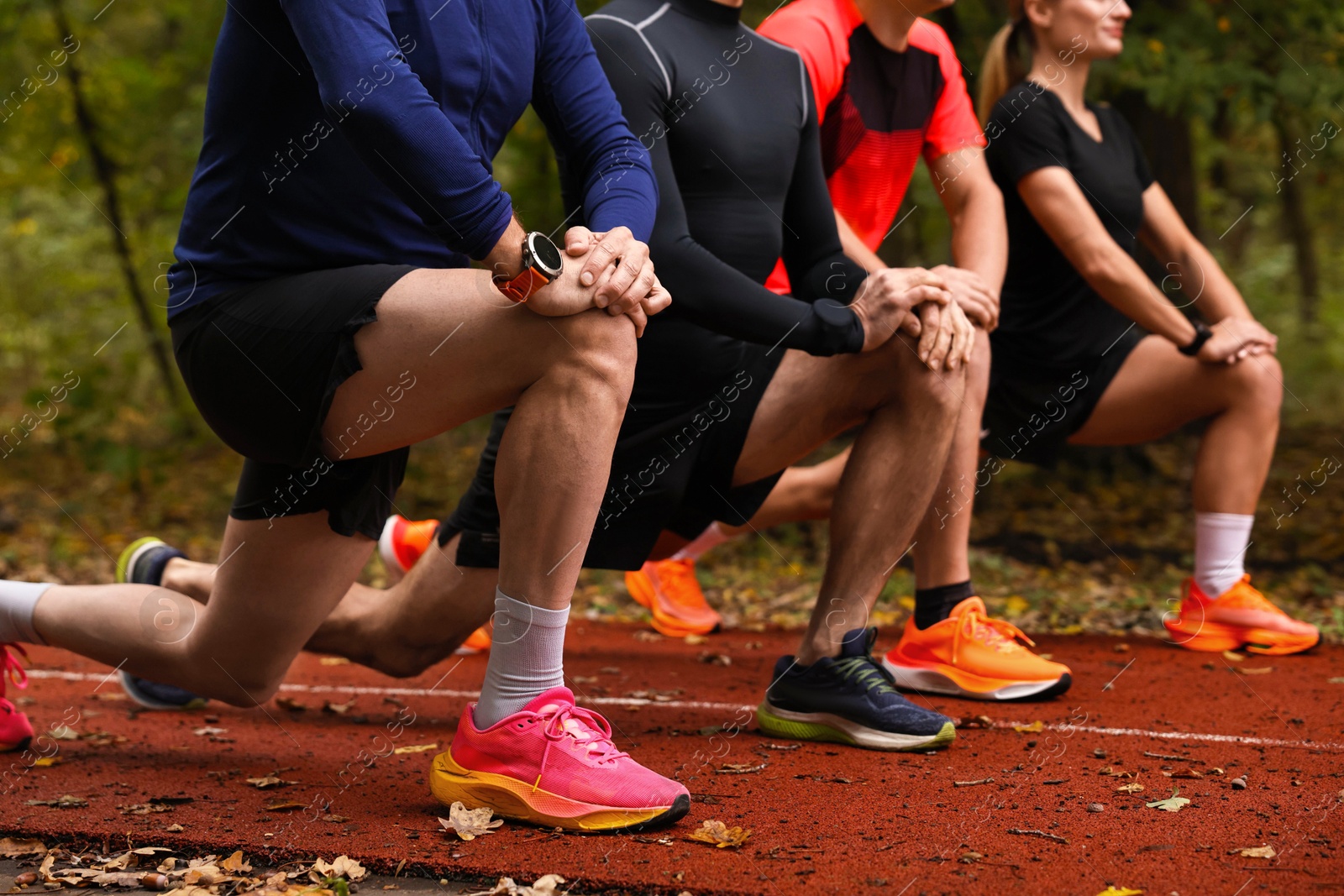 Photo of Group of people stretching in park, closeup