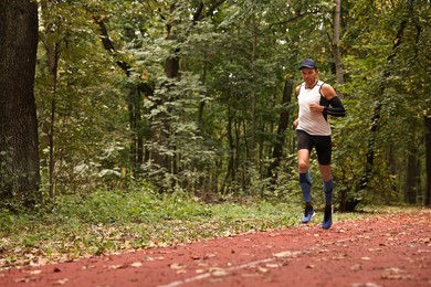 Photo of Athletic man running in park, space for text