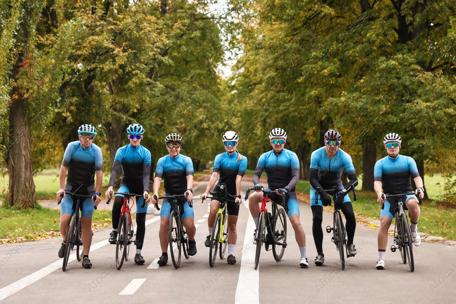 Photo of Group of athletic people with bicycles outdoors