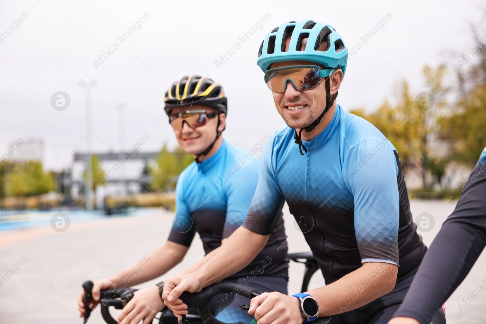 Photo of Group of athletic people with bicycles outdoors