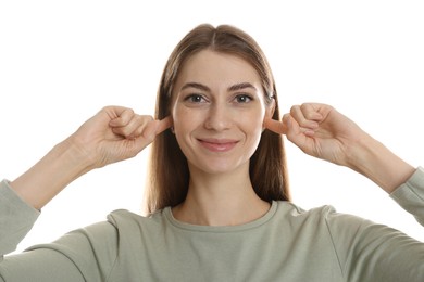 Photo of Woman covering her ears with fingers on white background