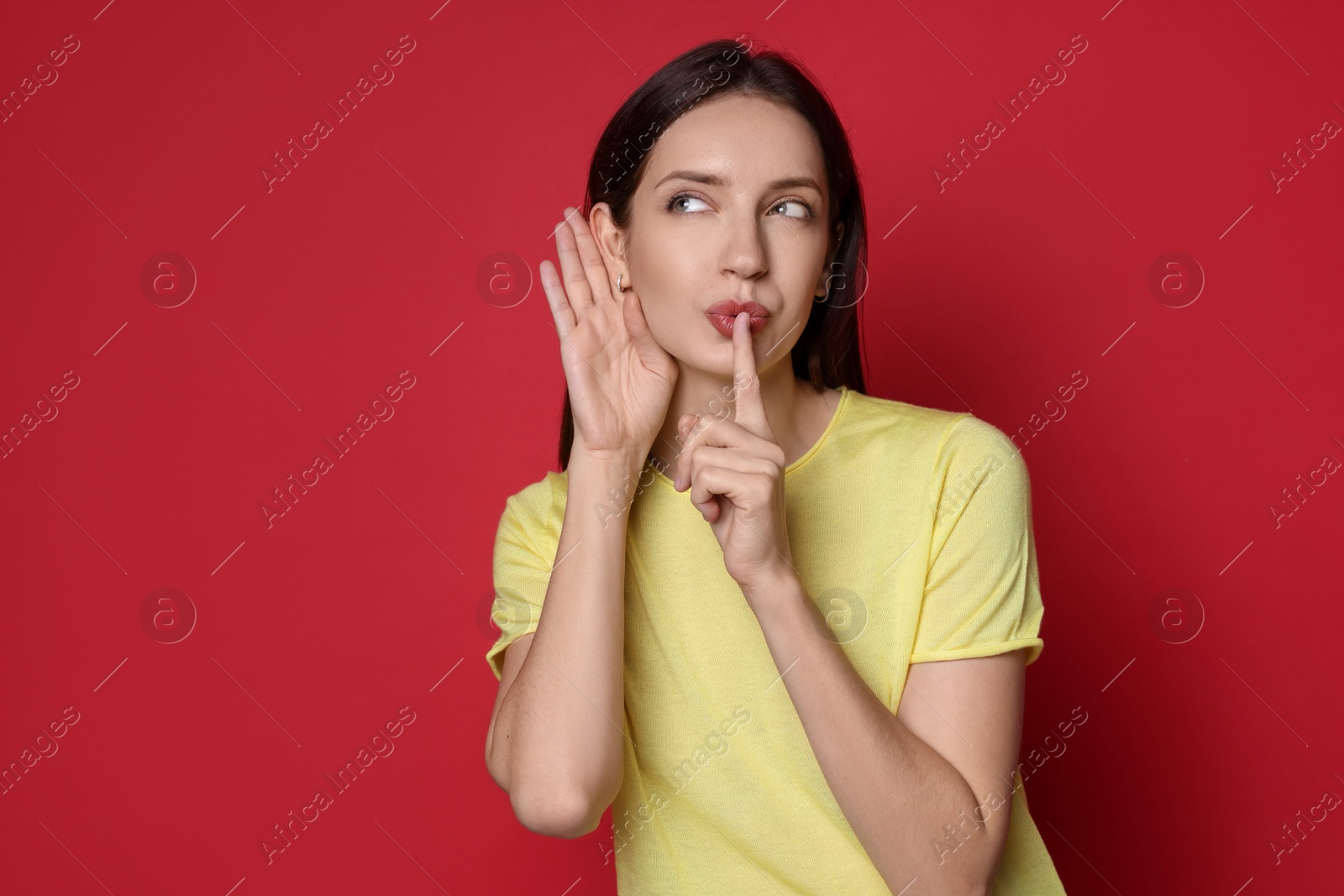 Photo of Woman showing hand to ear gesture on red background, space for text