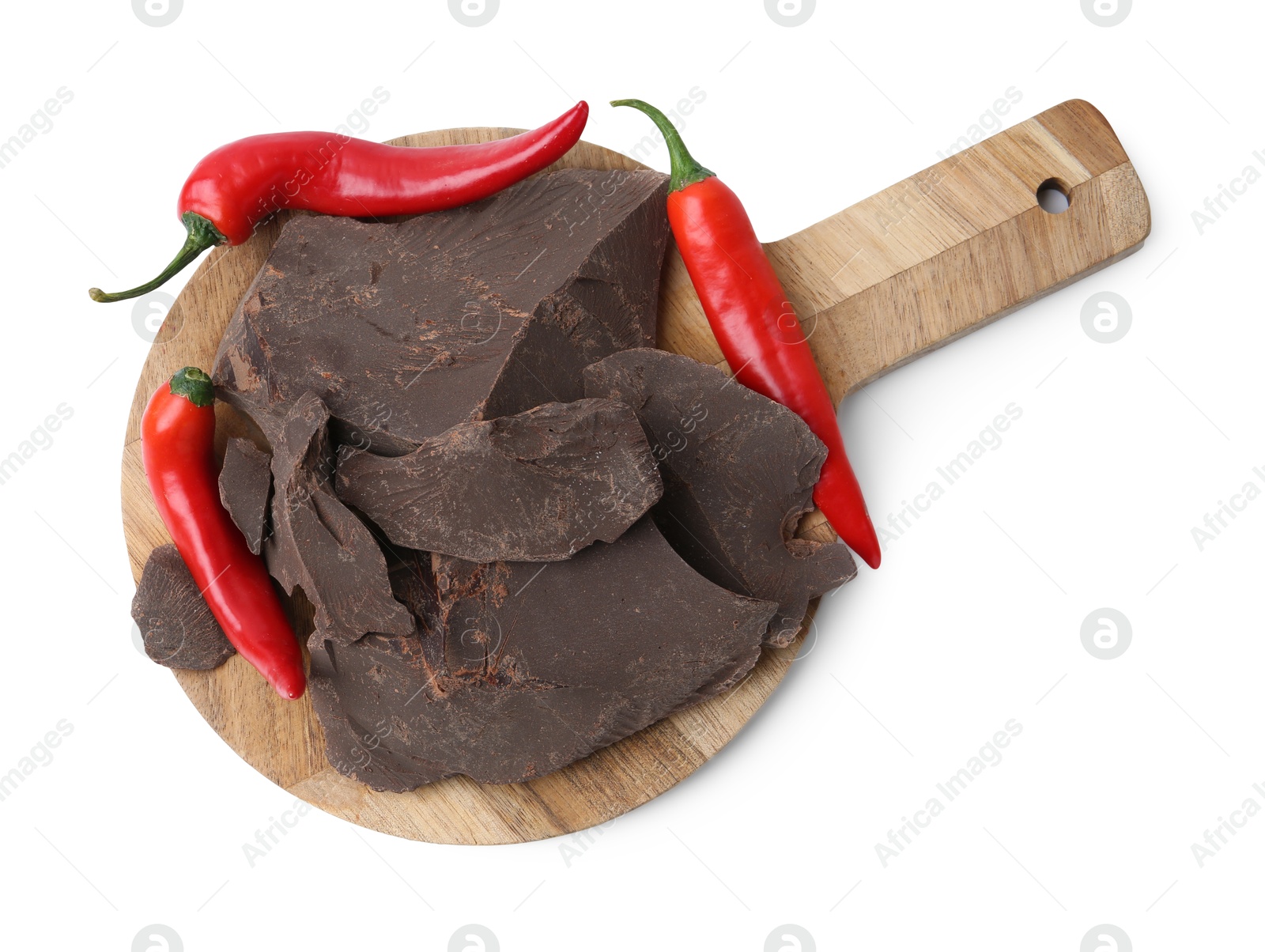 Photo of Pieces of tasty chocolate with chili peppers isolated on white, top view