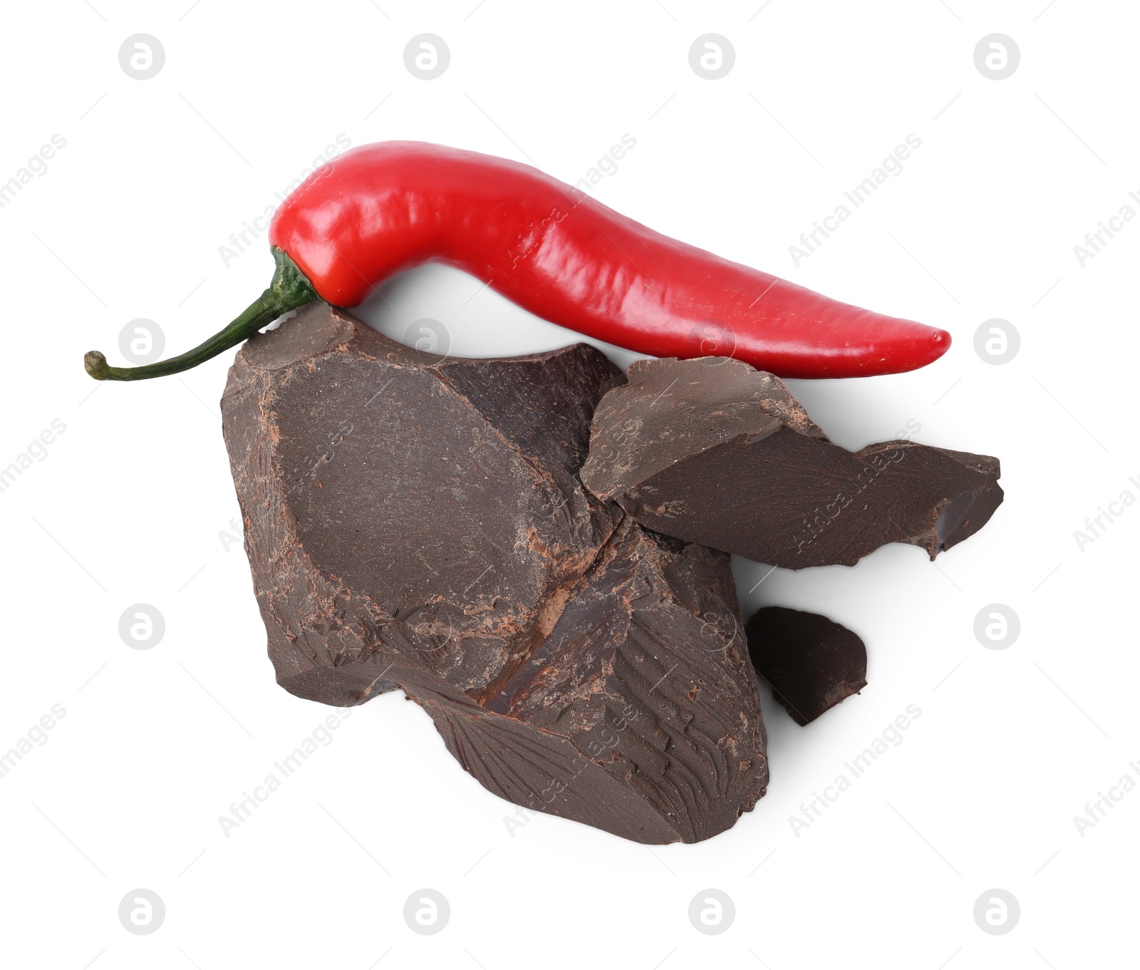 Photo of Pieces of tasty chocolate with chili pepper isolated on white, top view