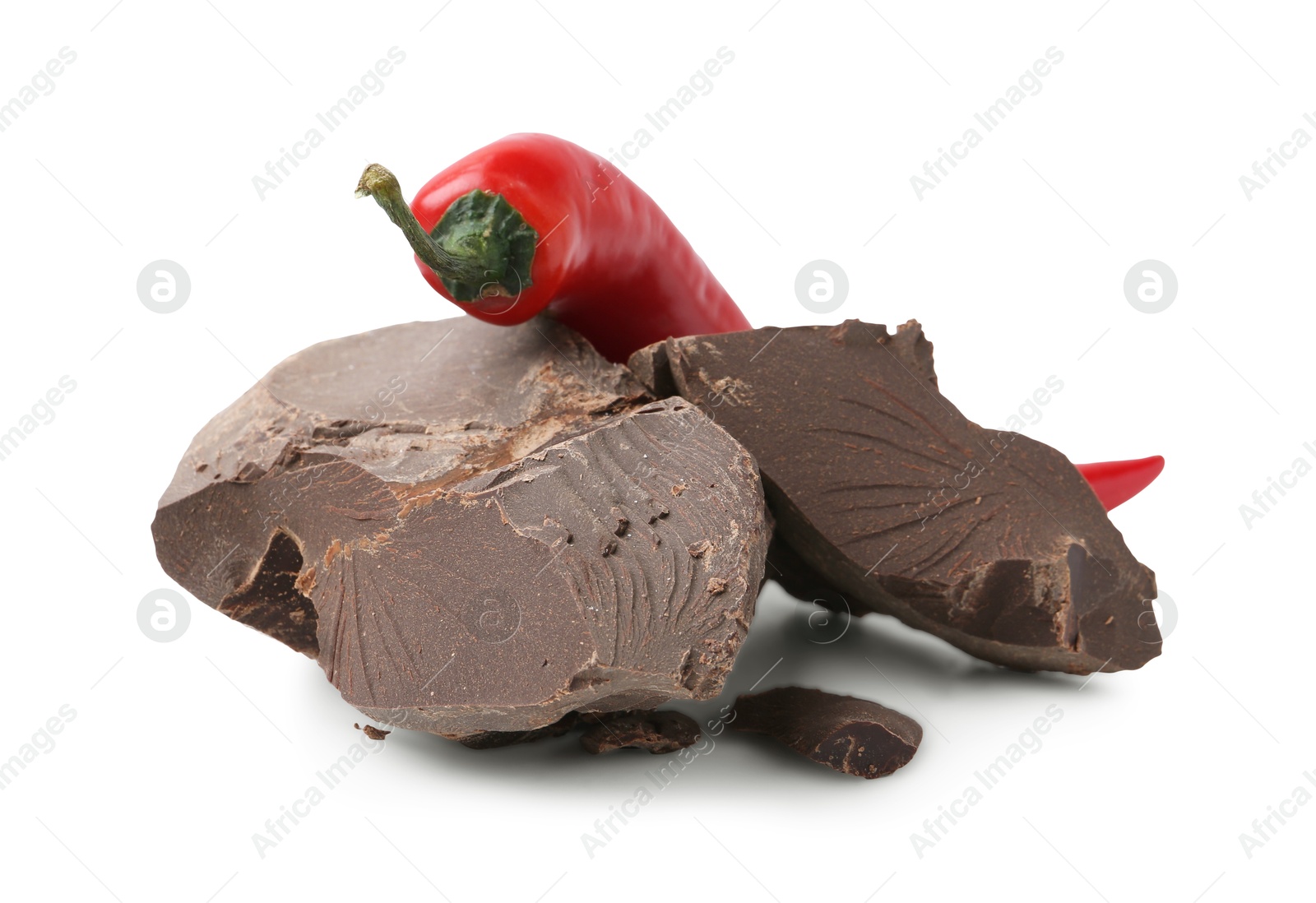 Photo of Pieces of tasty chocolate with chili pepper isolated on white