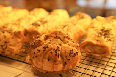 Photo of Tasty puff pastries on display in cafe, closeup