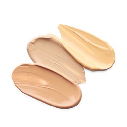 Photo of Skin foundation isolated on white, top view. Samples of cosmetic product