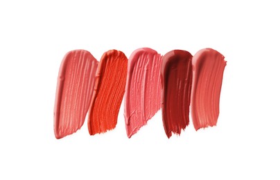 Photo of Different lipsticks isolated on white, top view. Samples of cosmetic product