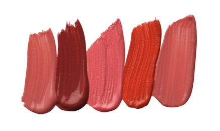 Photo of Different lipsticks isolated on white, top view. Samples of cosmetic product