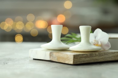 Photo of Spa stones and orchid flower on grey table, closeup. Space for text