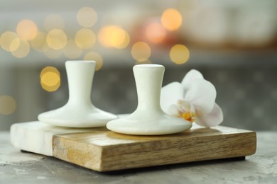 Photo of Spa stones and orchid flower on grey table, closeup