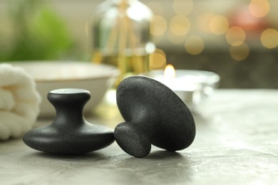 Massage stones on grey background, closeup. Spa treatment