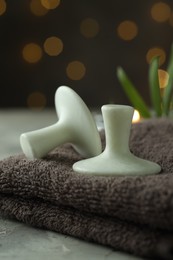 Photo of Spa stones and towel on grey table, closeup