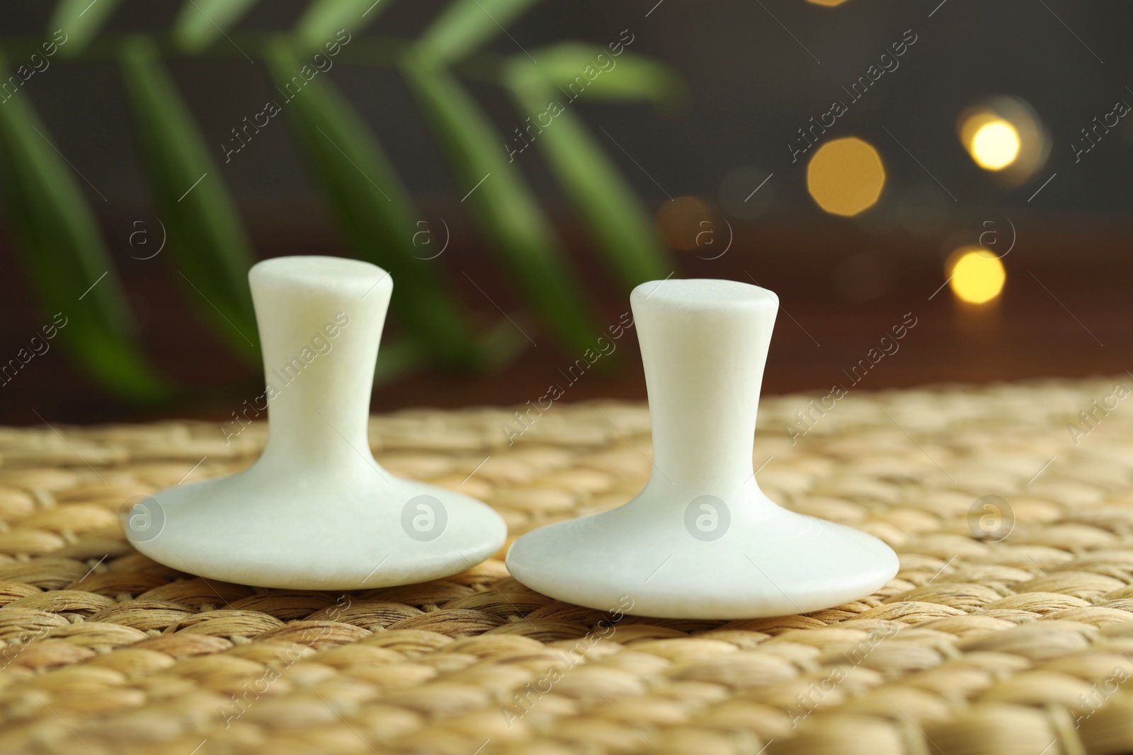 Photo of Two spa stones on wicker mat, closeup