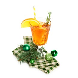 Photo of Tasty Christmas cocktail in glass, baubles and fir tree branches isolated on white