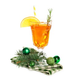 Photo of Tasty Christmas cocktail in glass, baubles and fir tree branches isolated on white