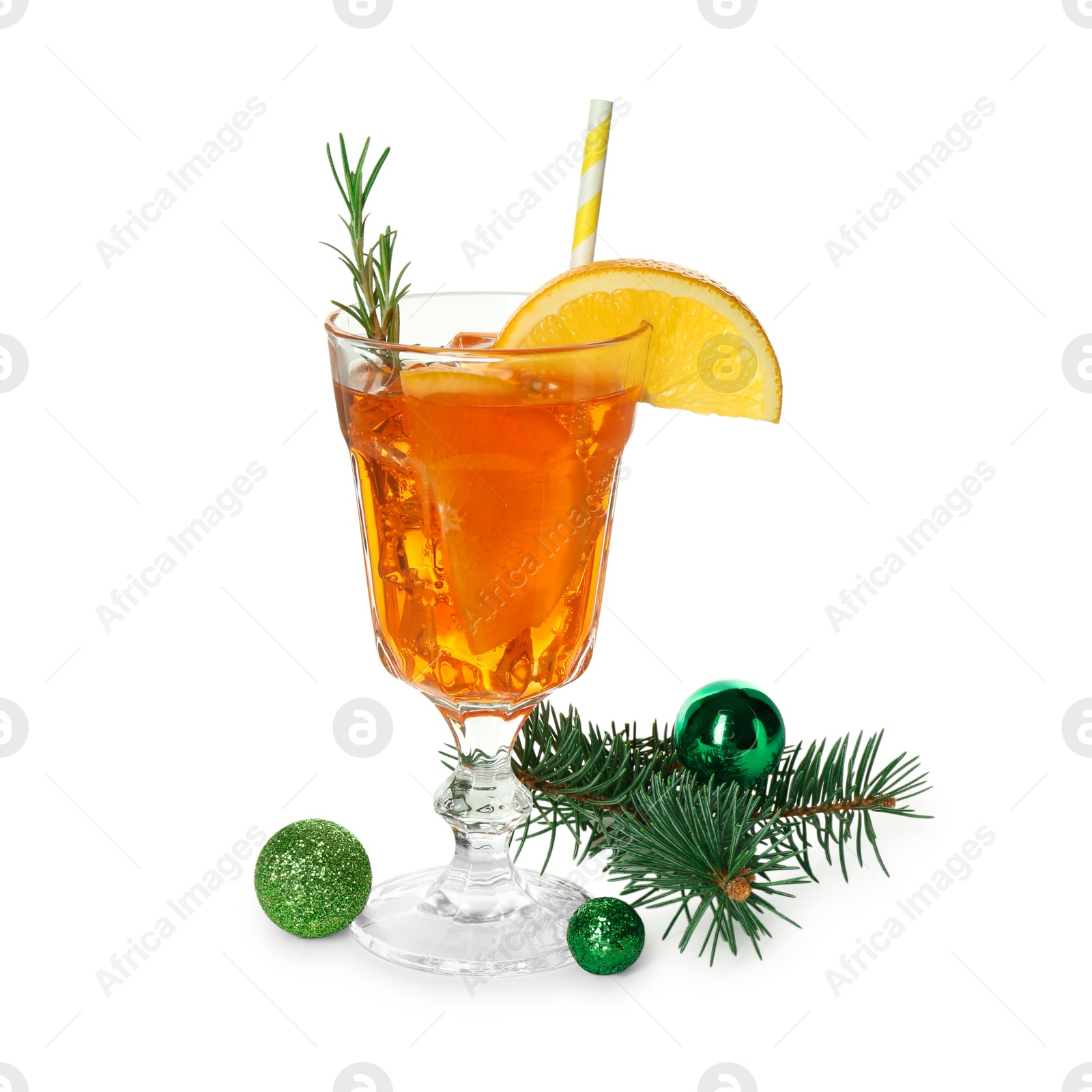 Photo of Tasty Christmas cocktail in glass, baubles and fir tree branches isolated on white