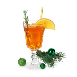 Photo of Tasty Christmas cocktail in glass, baubles and fir tree branches isolated on white