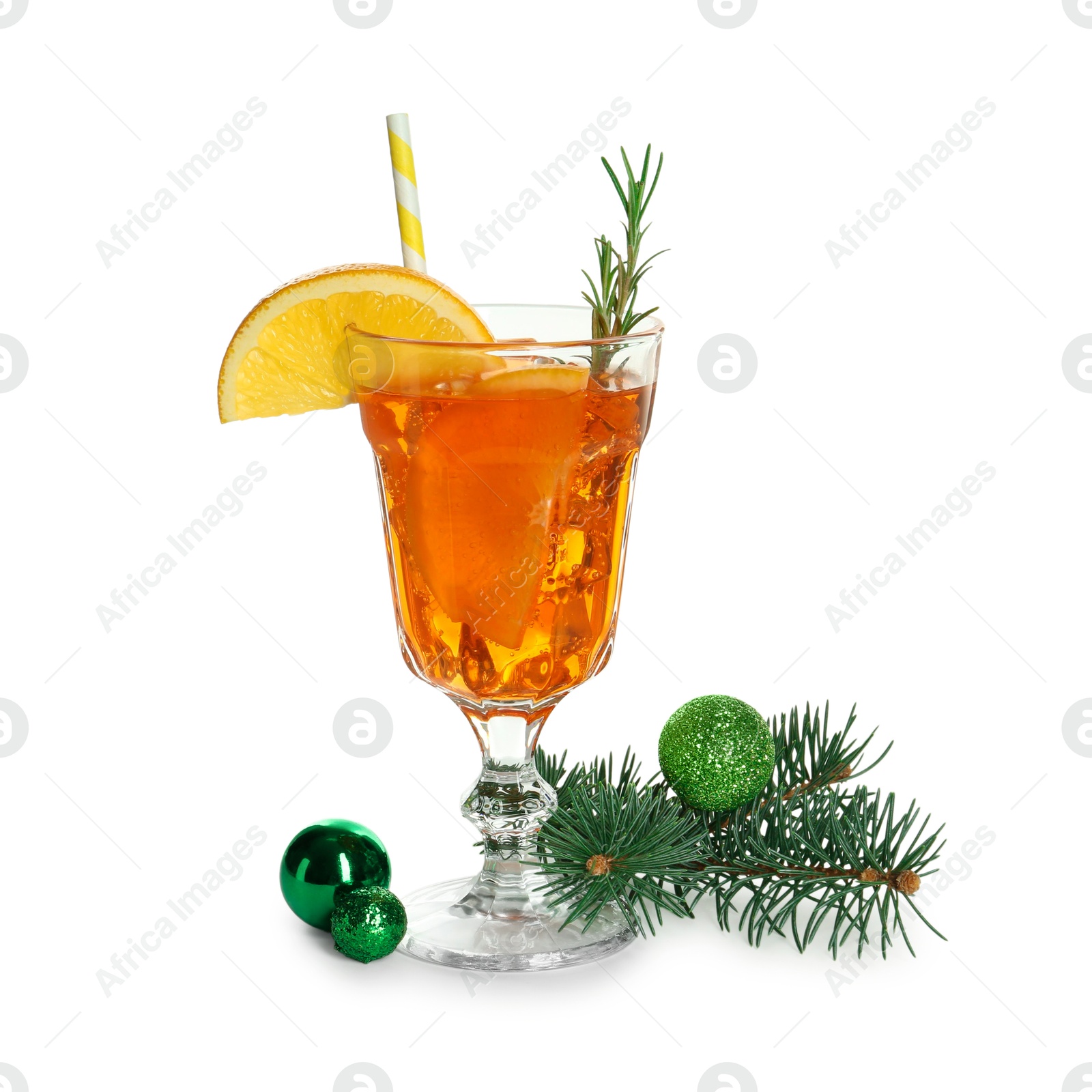 Photo of Tasty Christmas cocktail in glass, baubles and fir tree branches isolated on white